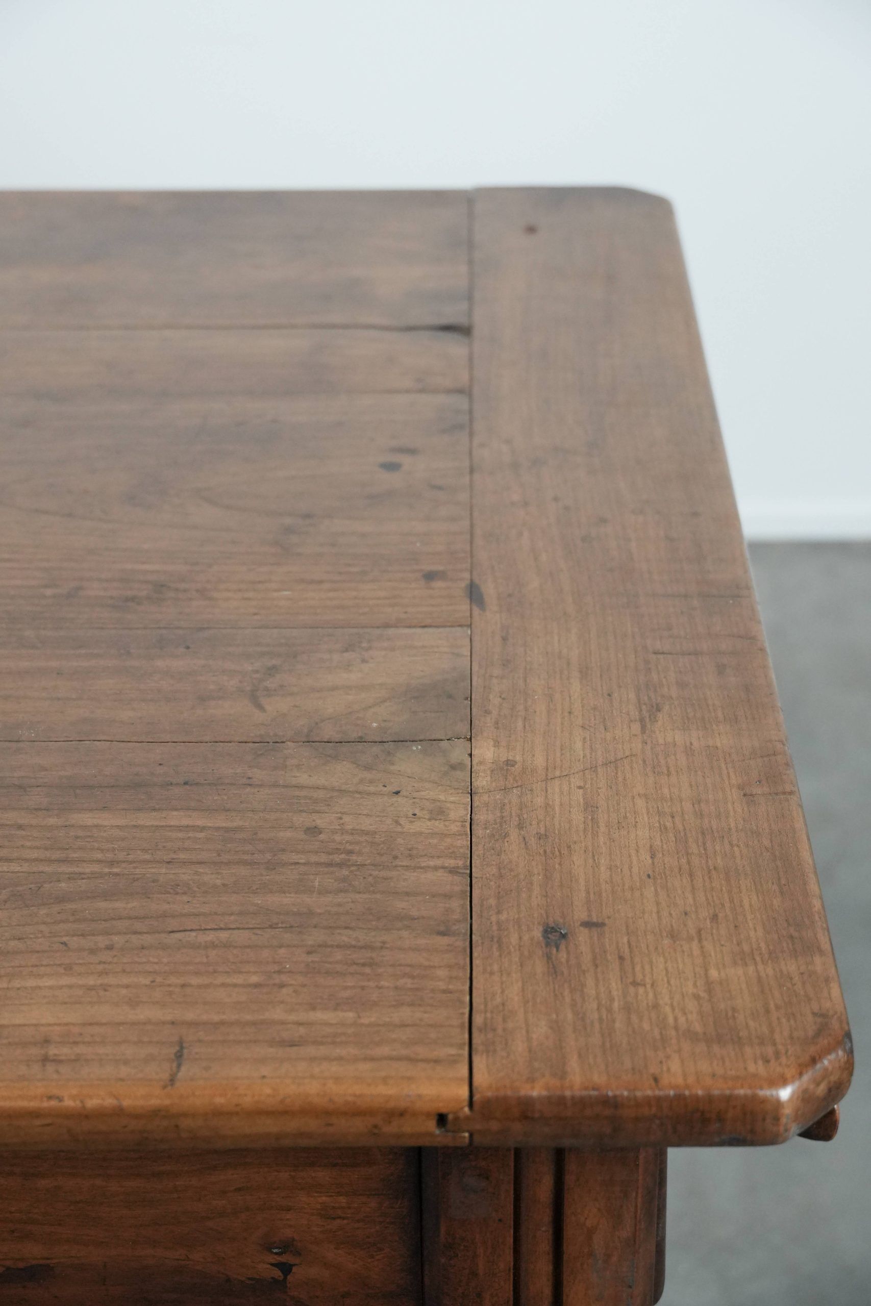 Antique French farmhouse dining table with two drawers and a pull-out board