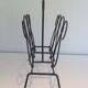 Magazine rack in leather and black lacquered metal. Attributed to Jacques Adnet