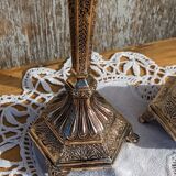 Pair of chiseled metal candle holders