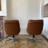 Pair of cognac-colored swivel armchairs