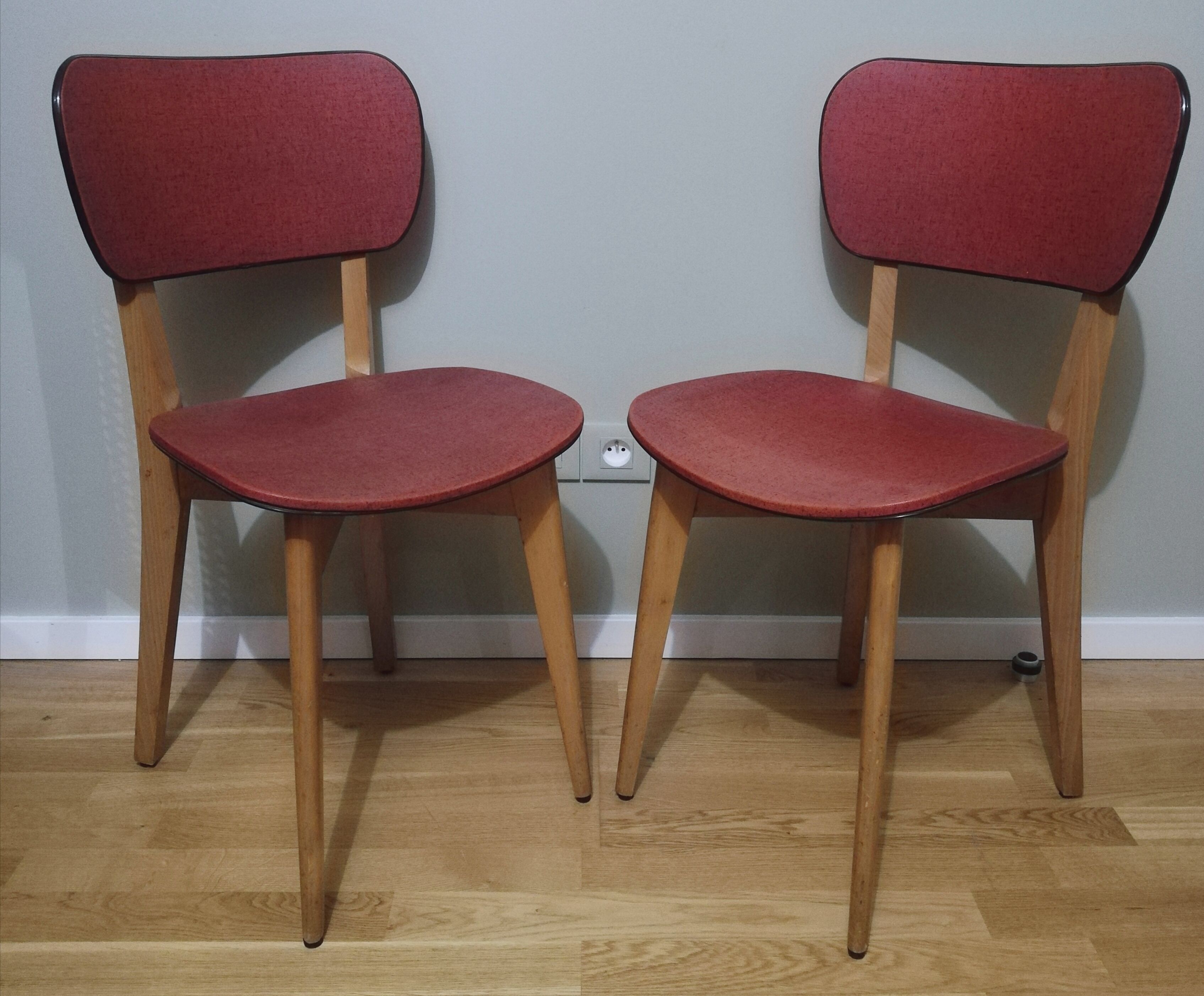 Two vintage chairs wood and mottled red vinyl