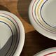 Set of 9 small Italian dessert plates Primula with red and green trim.
