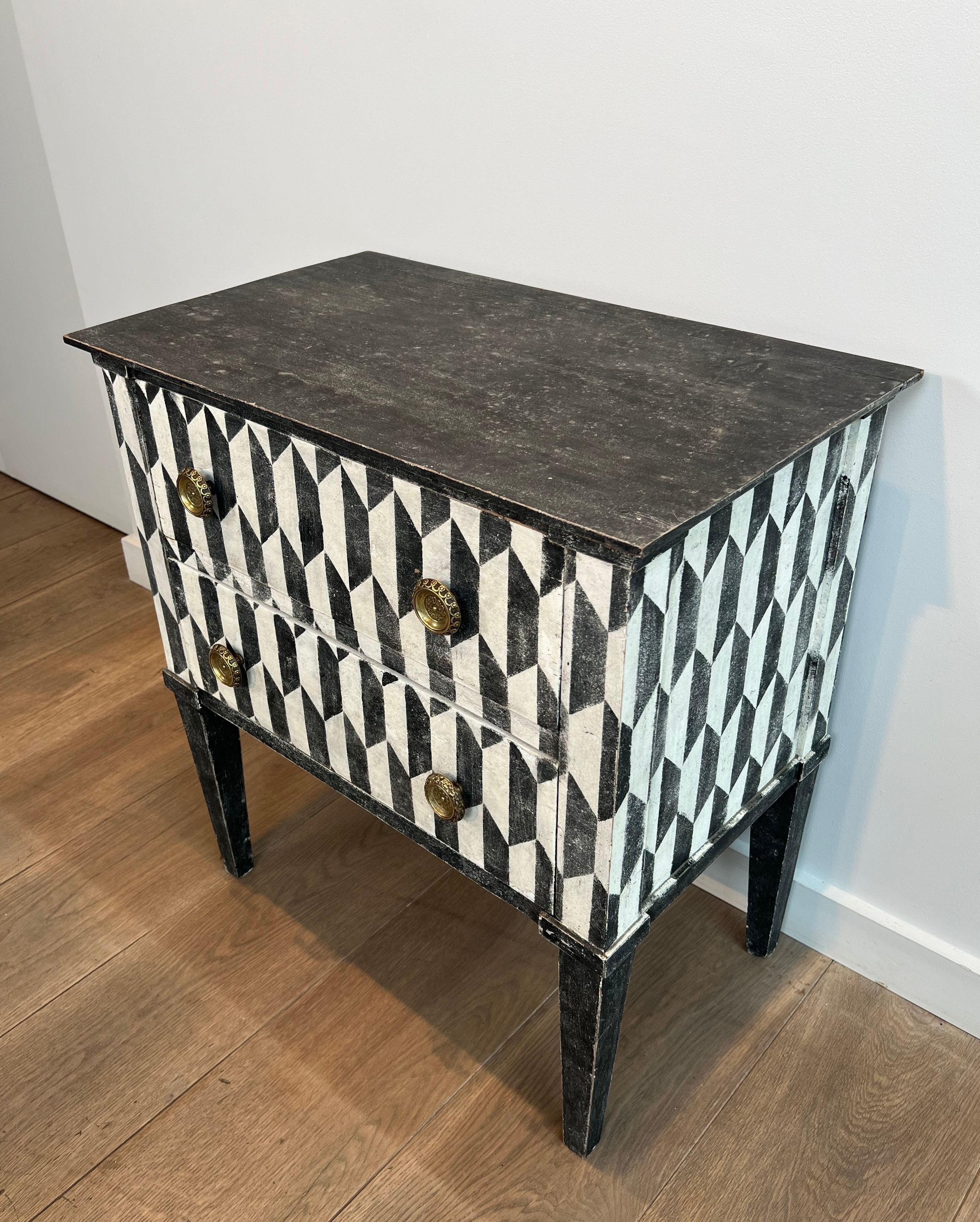 Small Italian chest of drawers with two drawers, patinated with a trompe-l'œil checkerboard pattern