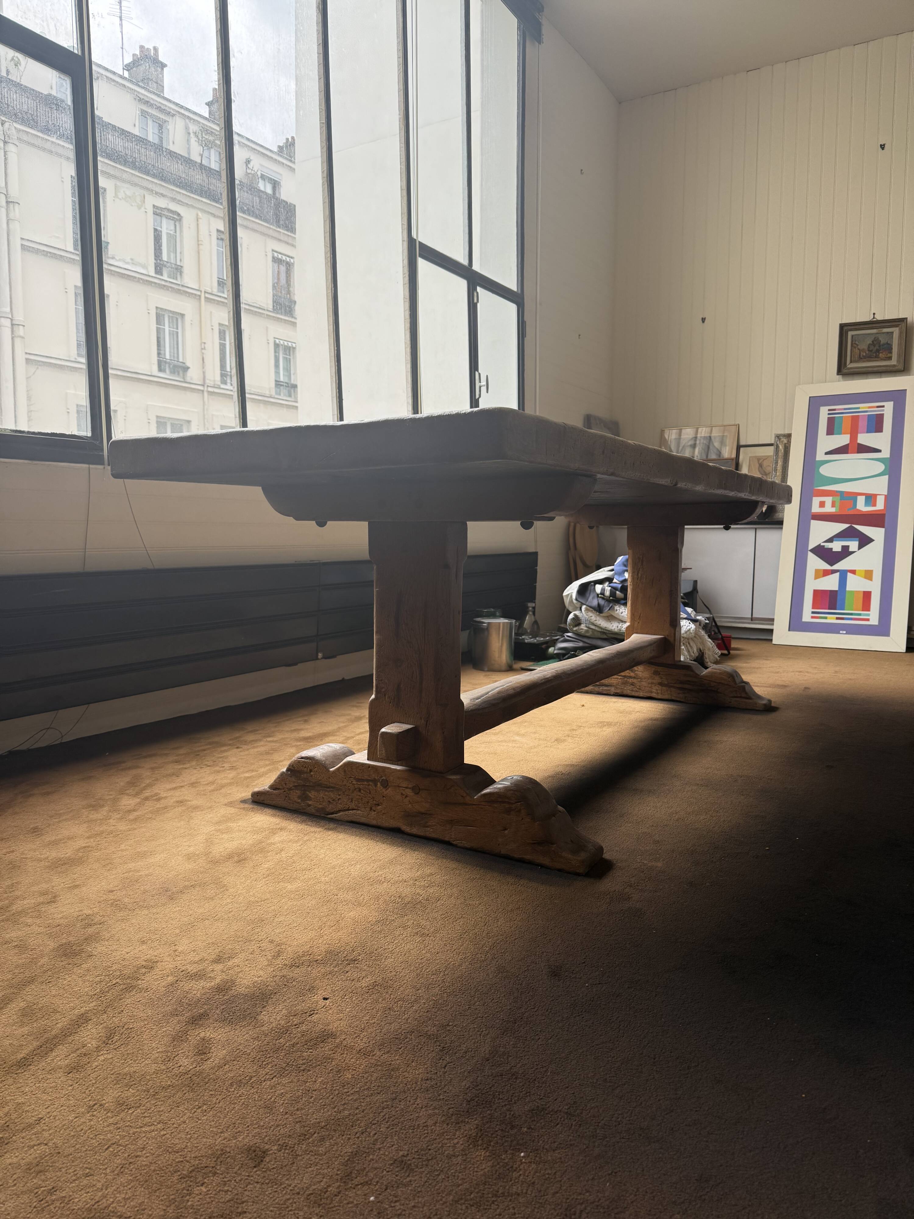Large antique farmhouse table made of solid wood, in monastery style.