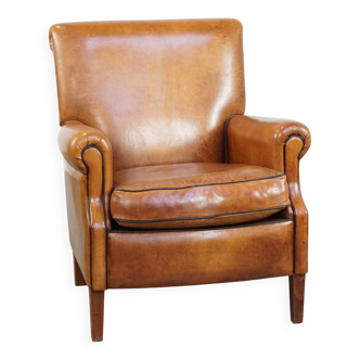 Fauteuil en cuir de mouton avec finition passepoilée noire