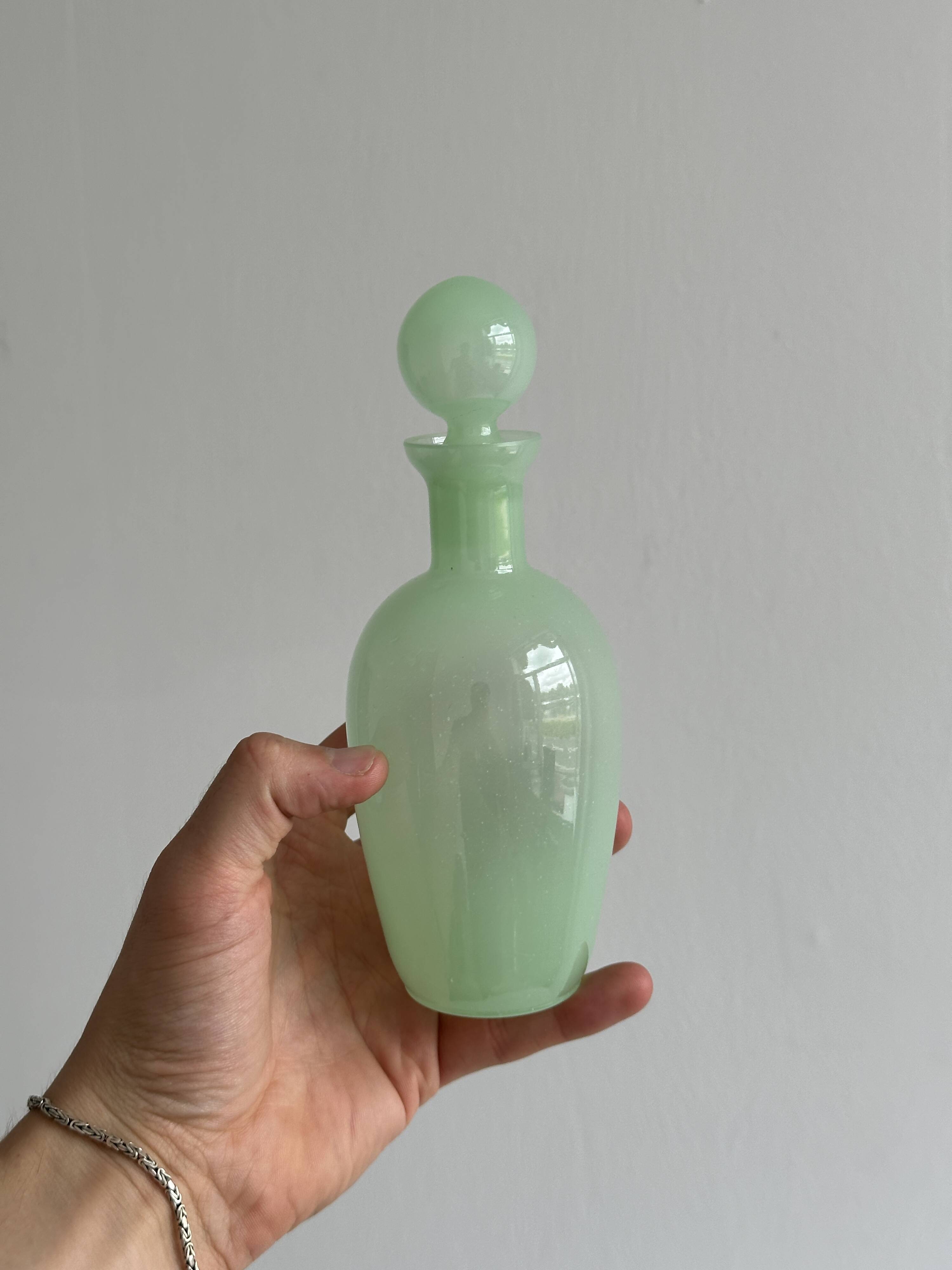 Opaque light green glass vial