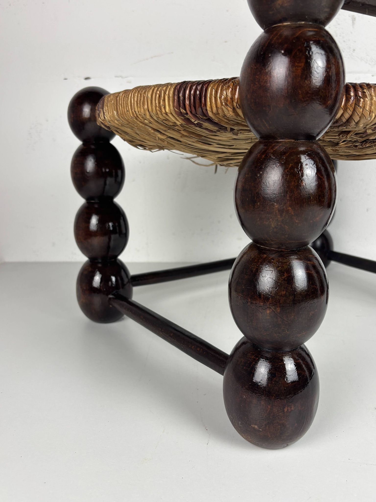 Brutalist wood turned bobbin low rush chair n the style of Charles Dudouyt
