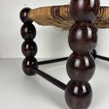 Brutalist wood turned bobbin low rush chair n the style of Charles Dudouyt