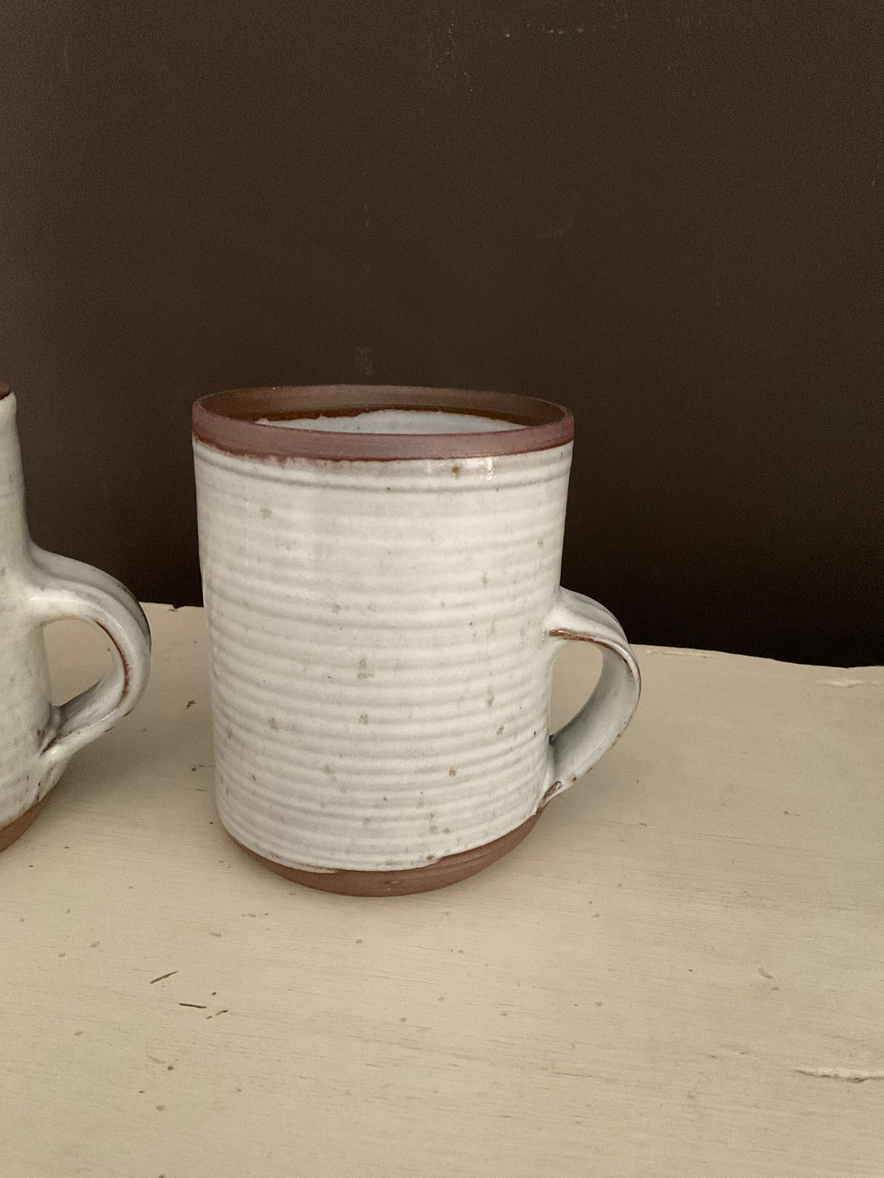 2 Mugs in Sandstone.Roger Jacques St Amand .vintage