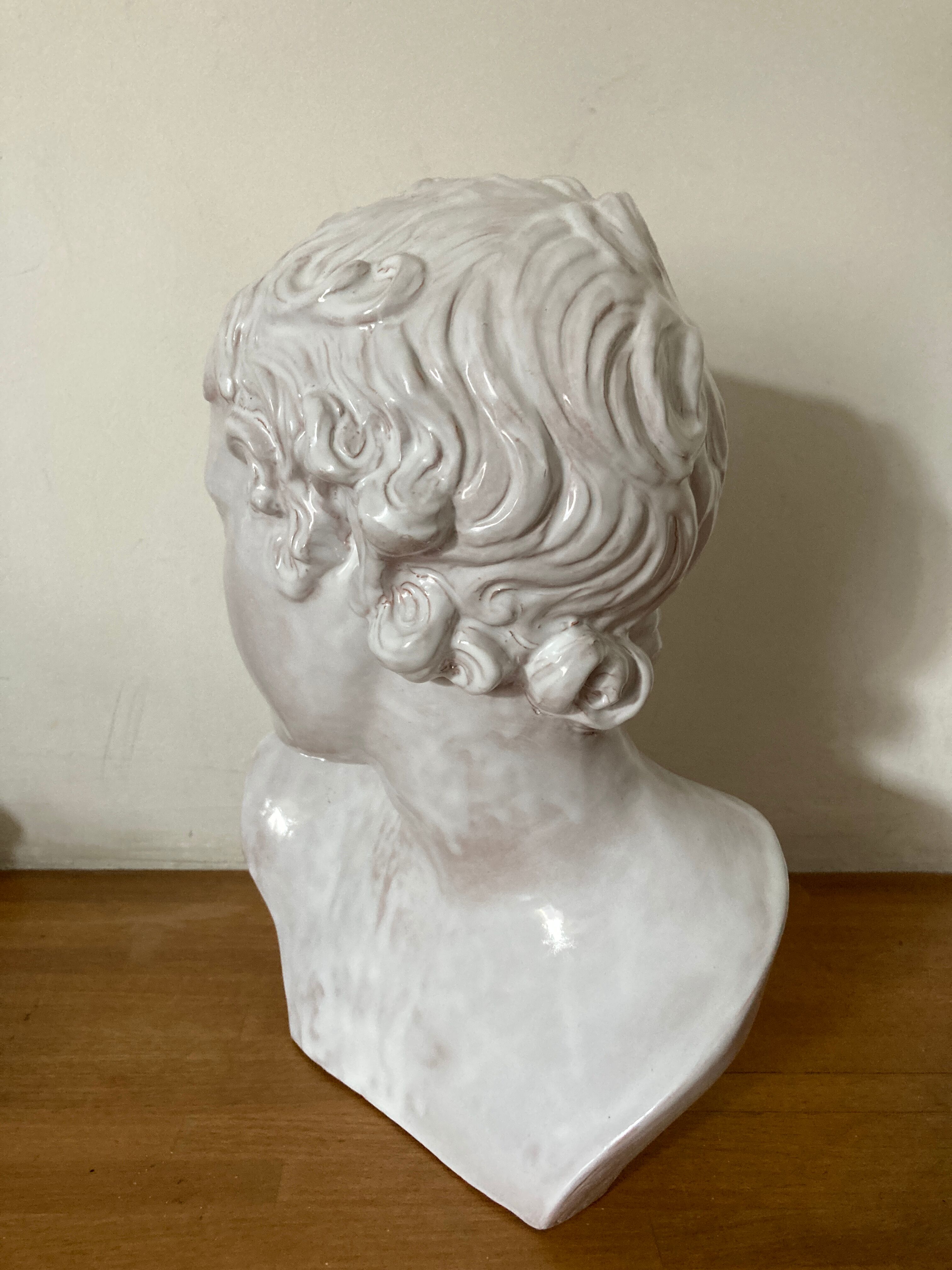 White enamelled terracotta Eros bust