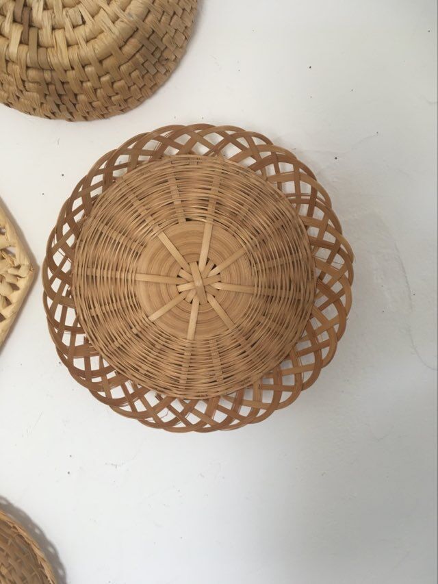 Wall composition of 9 wicker baskets and trays.