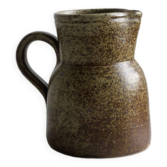 Speckled brown ceramic pitcher.