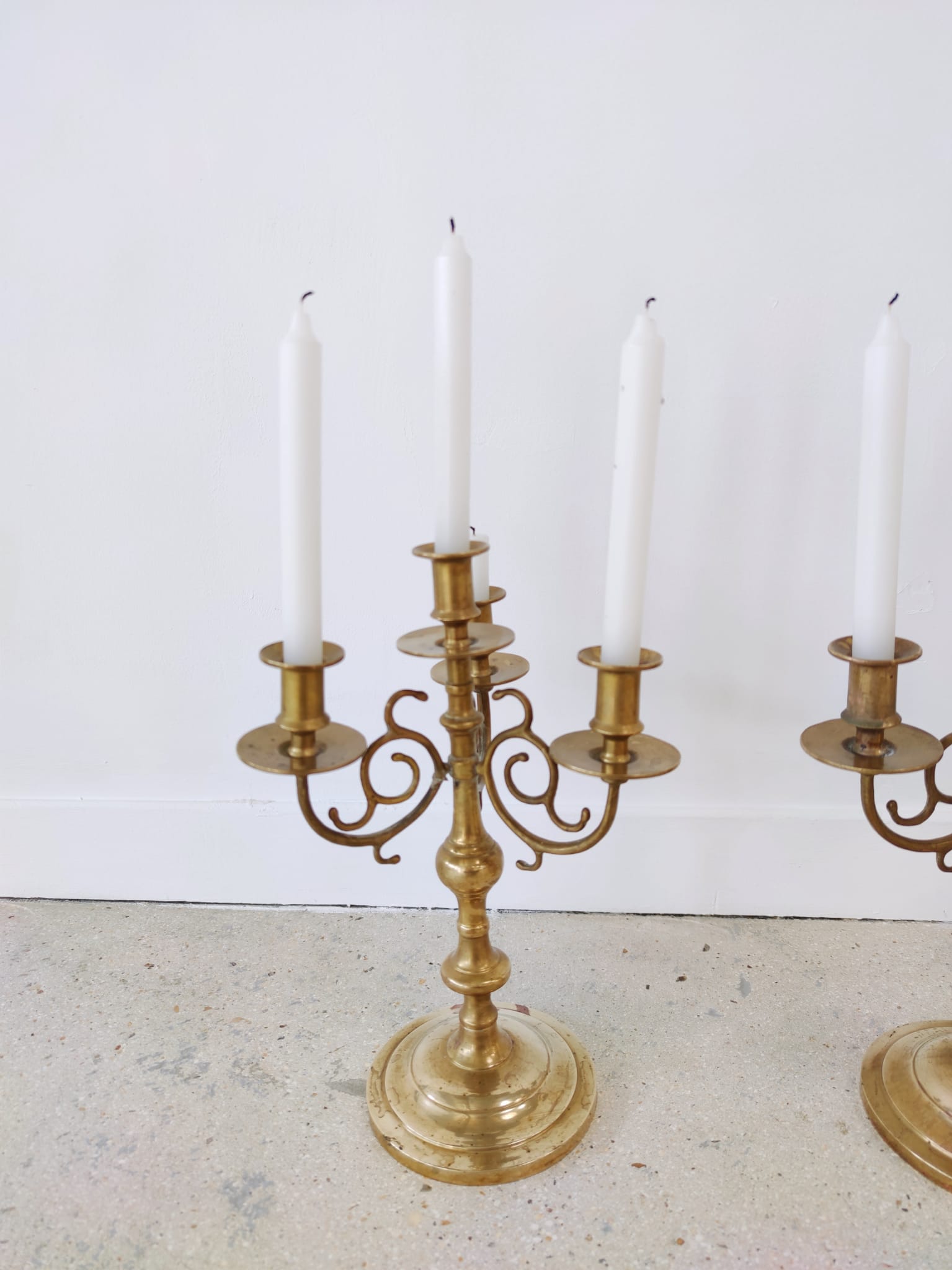 Pair of four-light candle holders in gilded brass