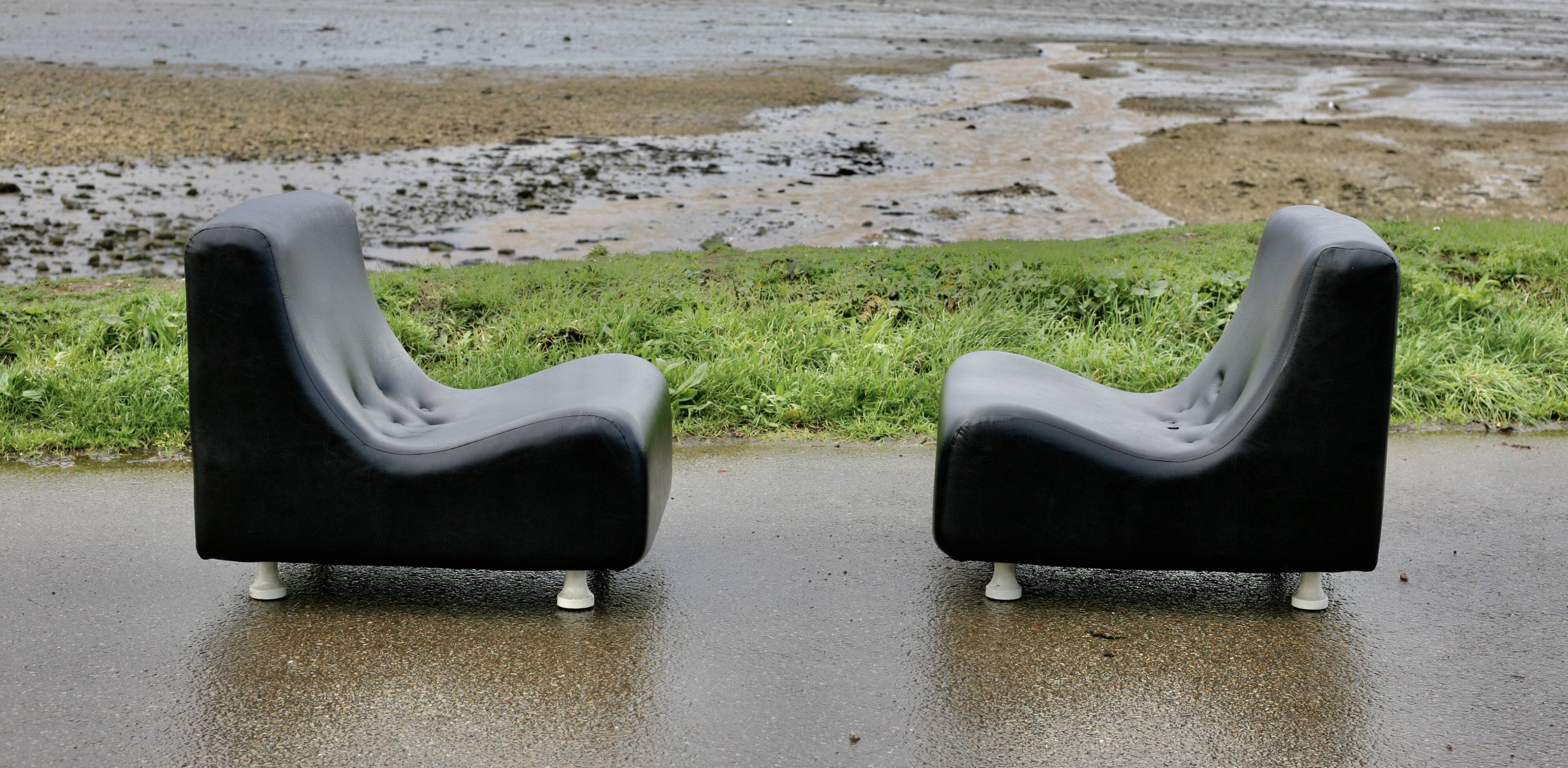 Pair of “space age” low chairs. Black faux leather. Circa 1970
