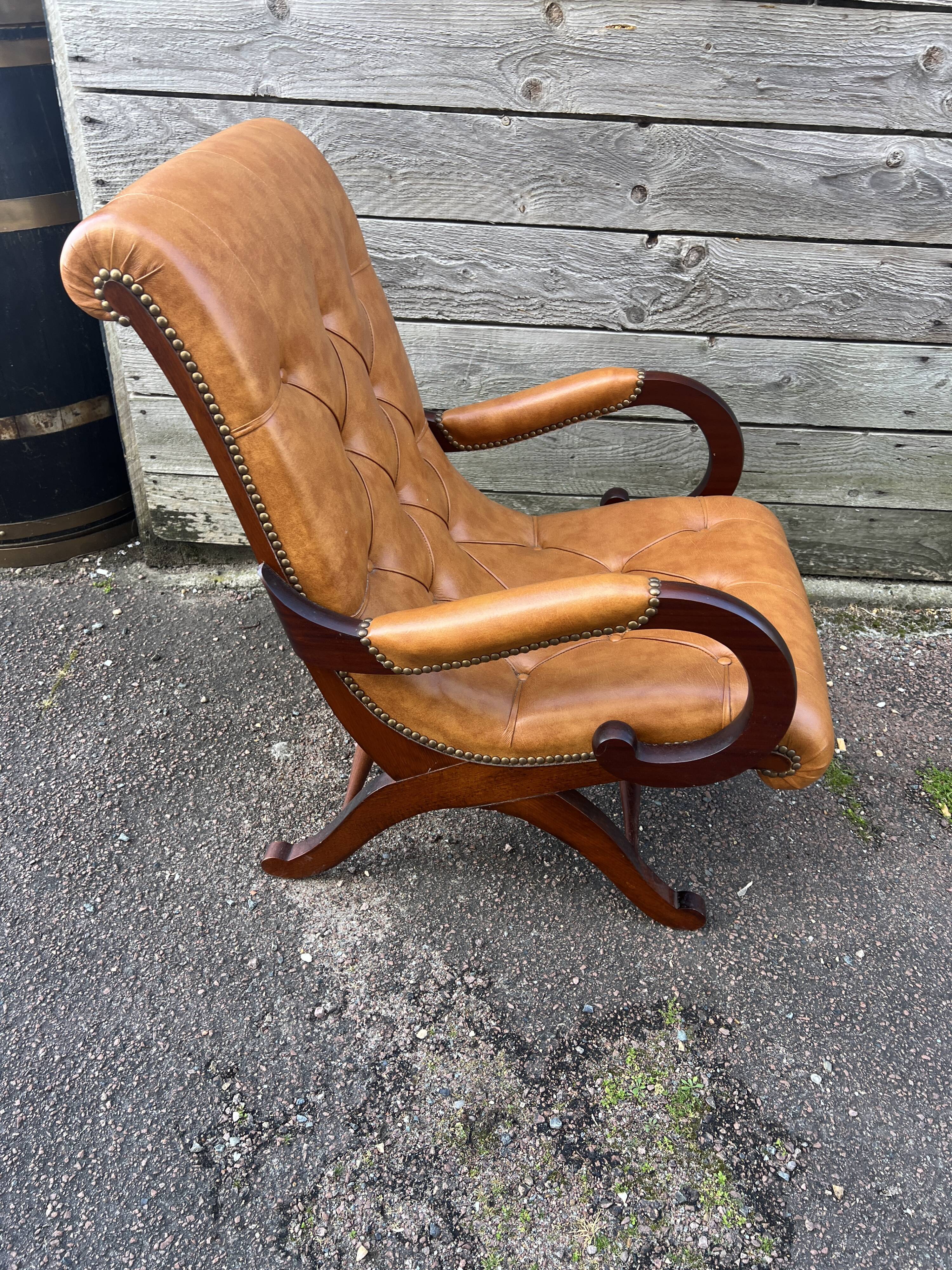 Chesterfield leather slipper chair with mahogany