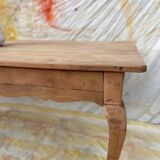 Curved farmhouse table in rustic wood, Provençal style.