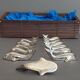 Lot 12 knife holders in the shape of a stylized whale or fish
