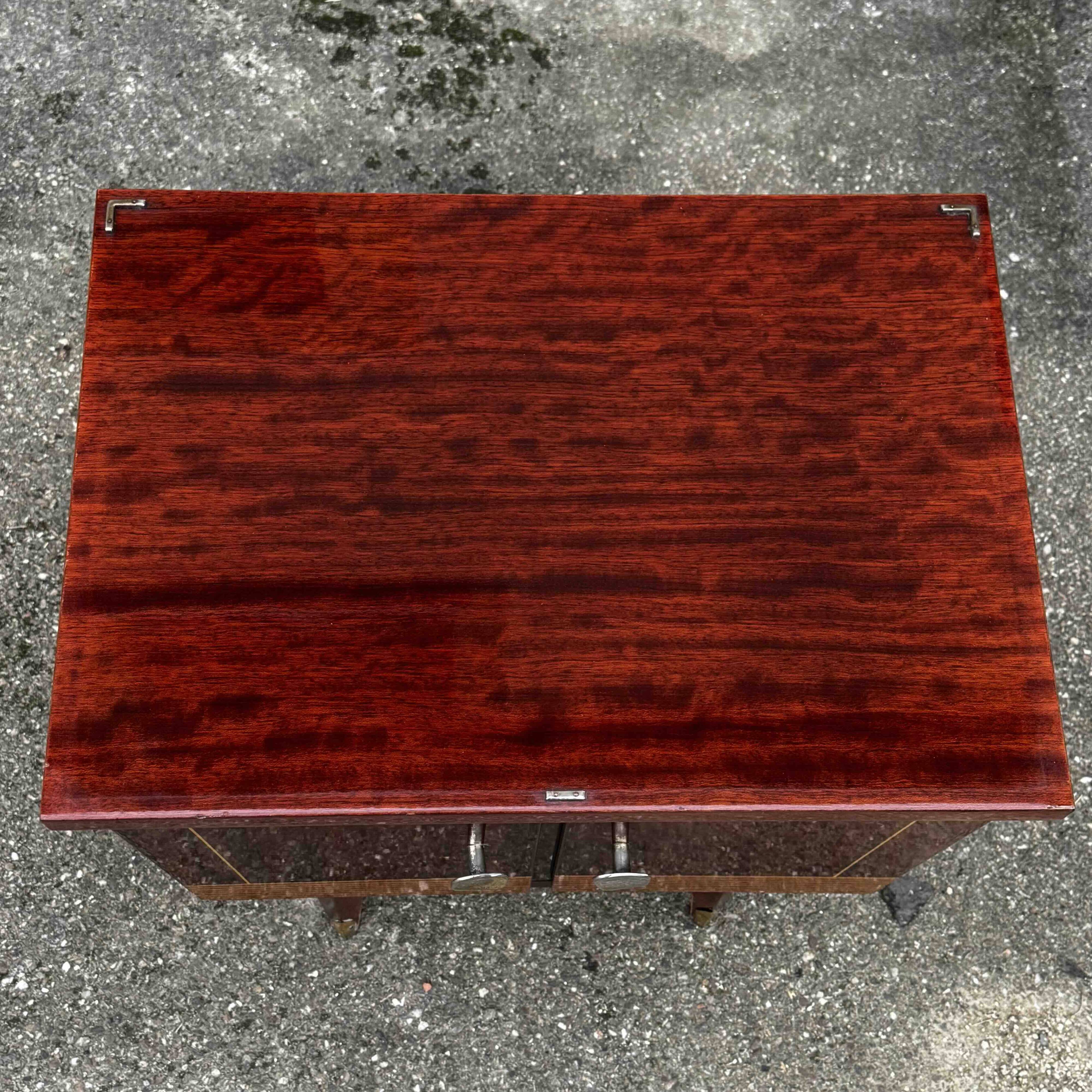 1950s bedside table in varnished wood veneer and brass.