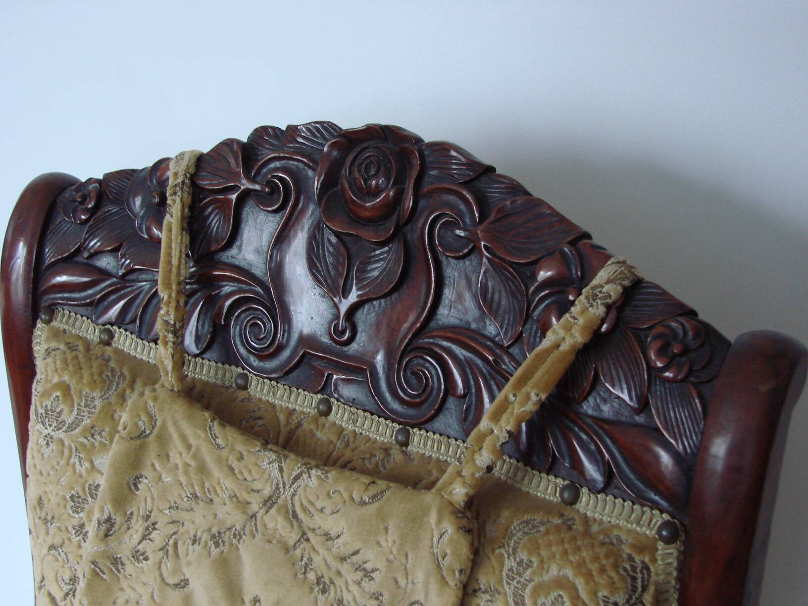 An antique armchair from the turn of the 19th and 20th centuries, carved wa