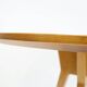 Round dining table in Wood Wood with brass details.