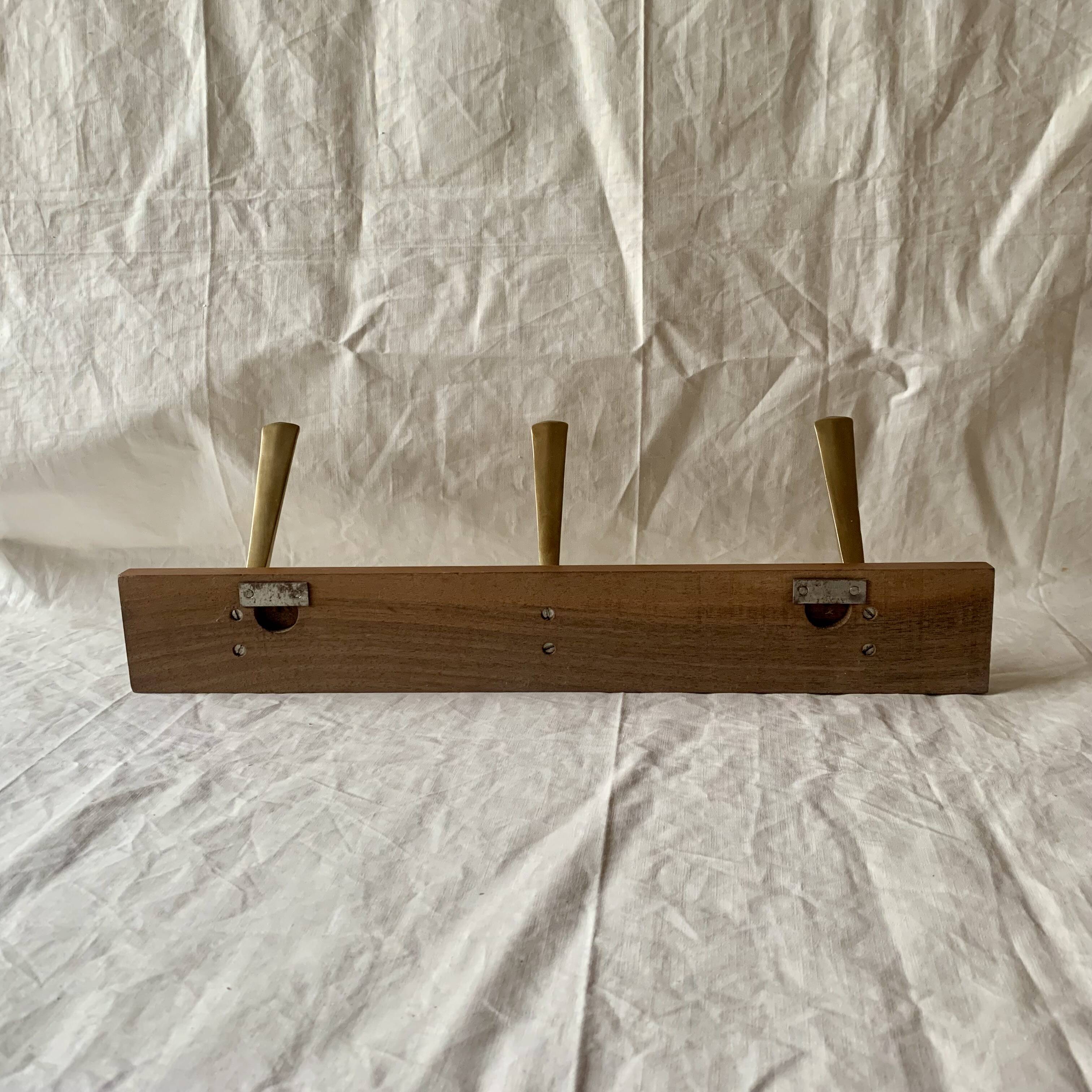 Vintage wooden wall-mounted coat rack with 3 golden cast aluminum hooks