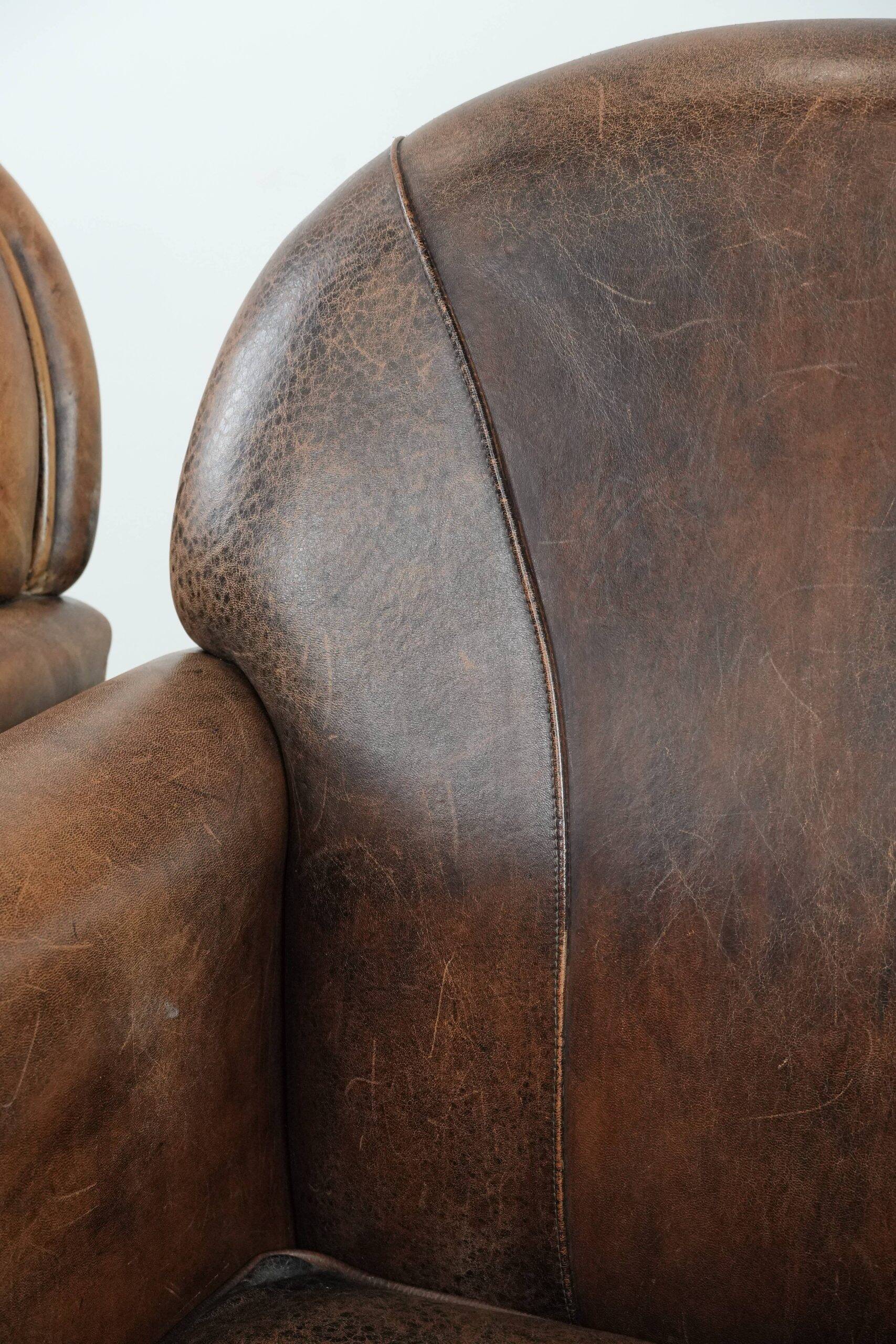 Set of 2 vintage sheepskin armchairs with a characterful appearance