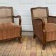 Pair of 1920s brown armchairs in carved wood and fabric, with caning detail.