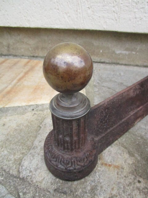 Pair of old cast iron chenets and brass ball