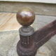 Pair of old cast iron chenets and brass ball