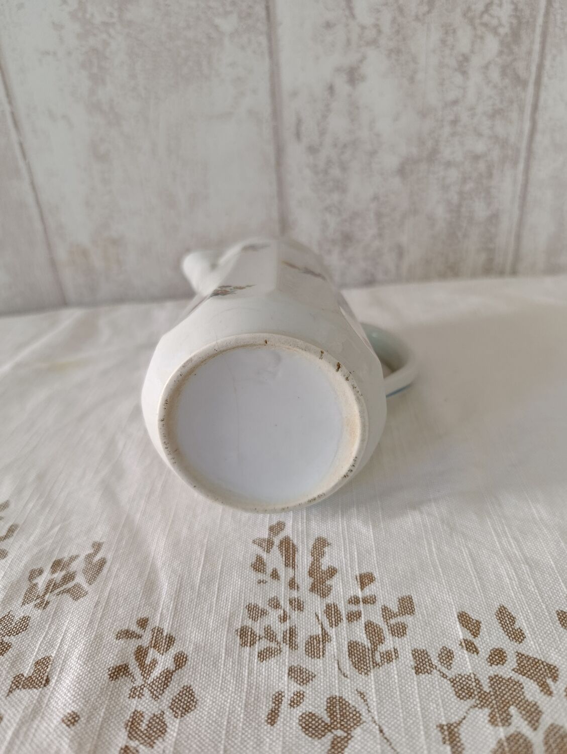 Earthenware milk jug with small flower patterns.