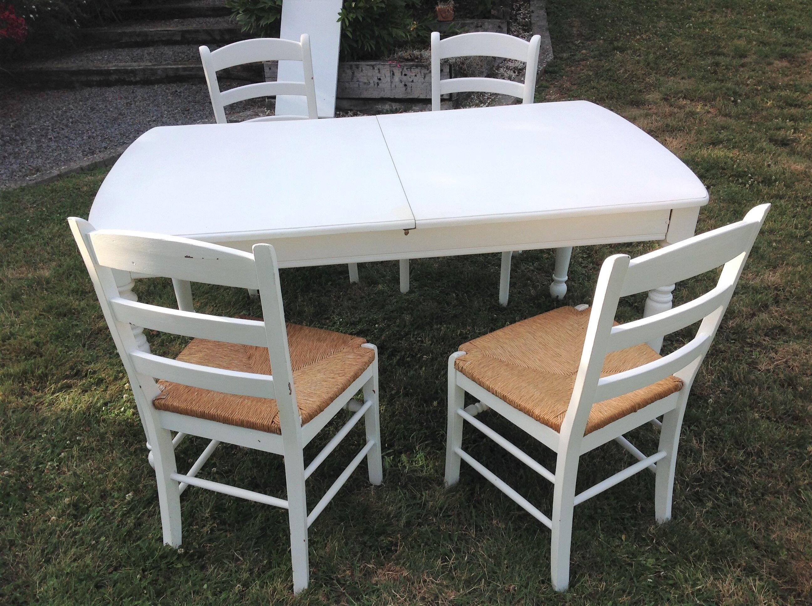 White farmhouse table set and four chairs