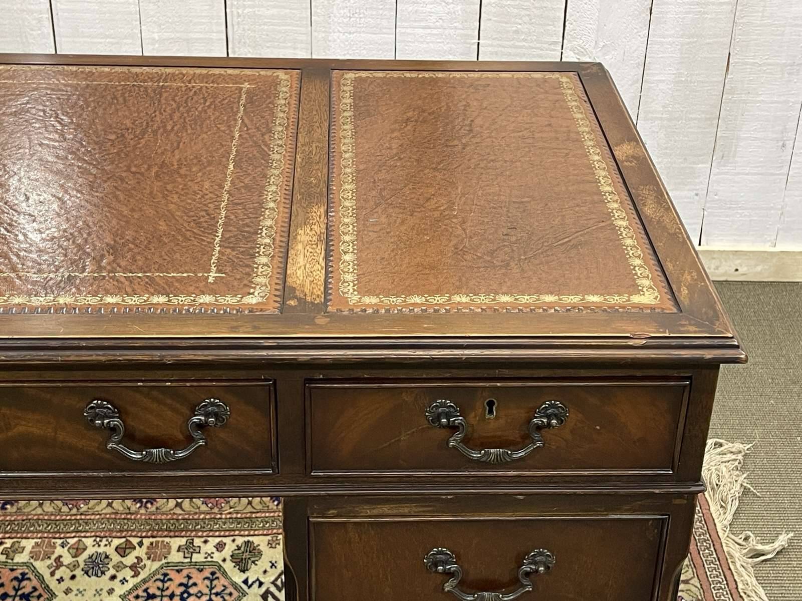 English mahogany pedestal desk with leather top from the 1950s