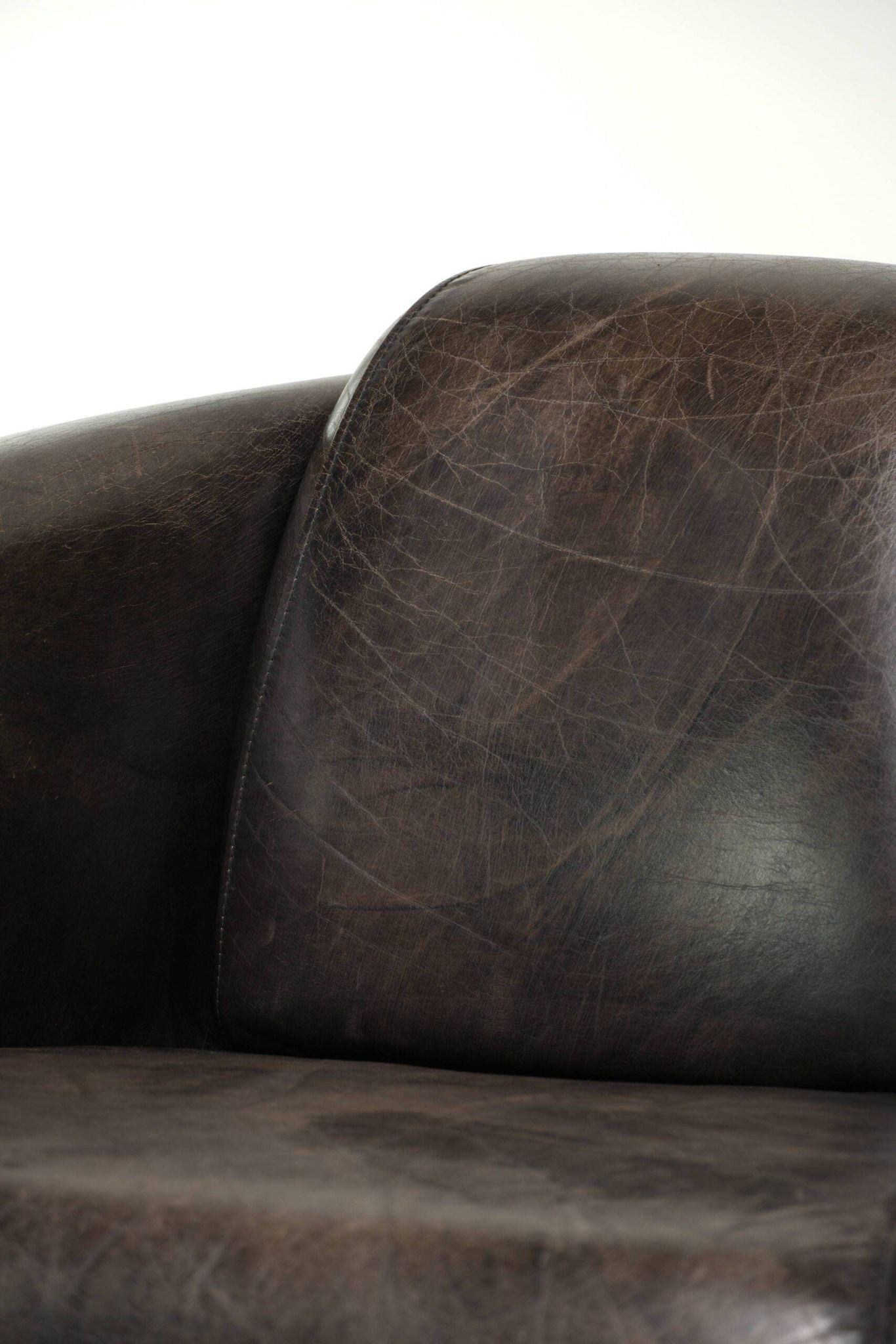 Cow leather Aviator design armchair in a dark colour scheme