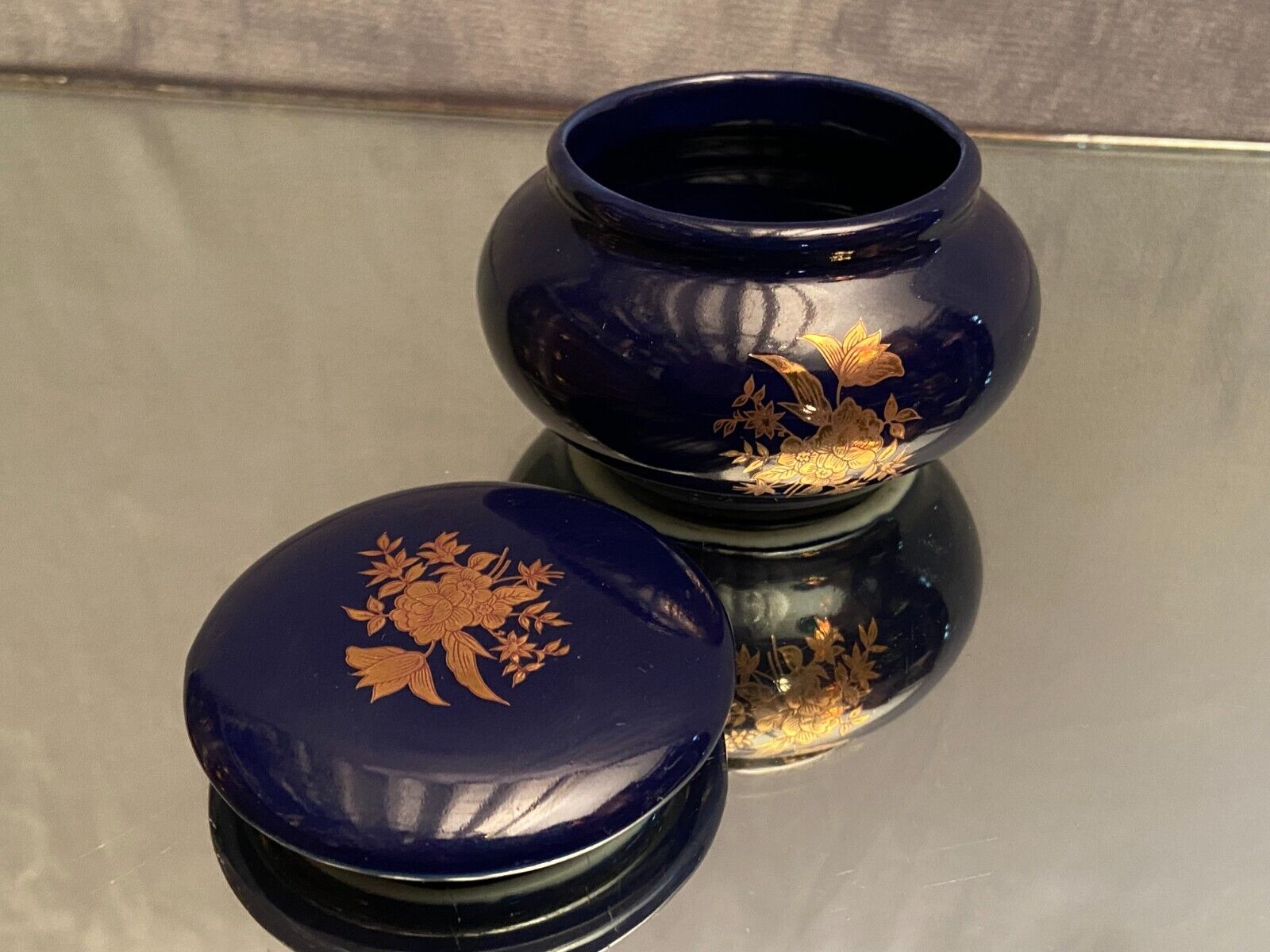 Porcelain candy box with golden floral decoration on a midnight blue background