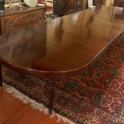 Extensible dining table from the Louis XVI period in mahogany with a banded top.