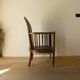 Antique armchair in solid wood and patinated brown leather, early 20th century.