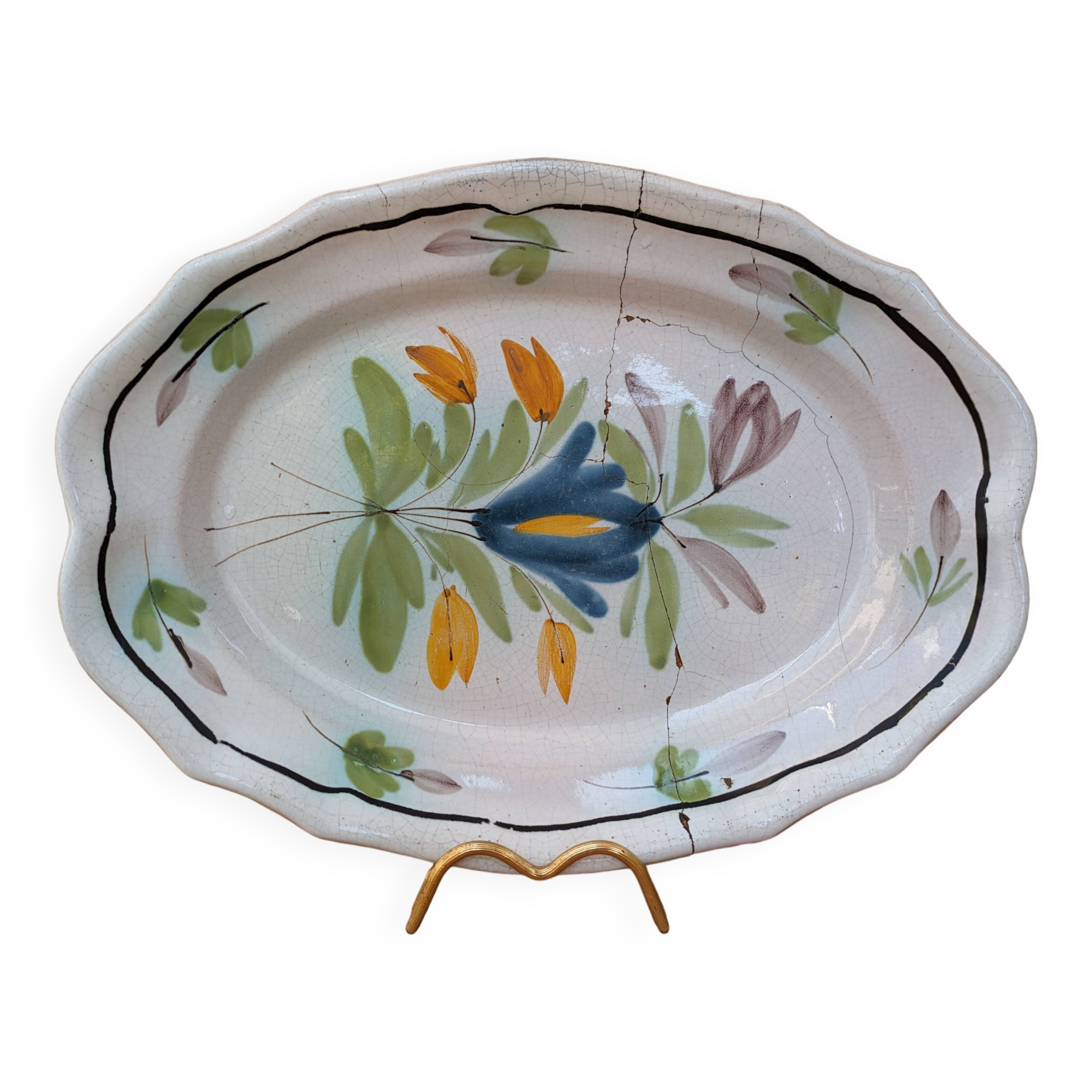Old oval dish with floral motif called black bottom with staples
