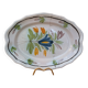 Old oval dish with floral motif called black bottom with staples