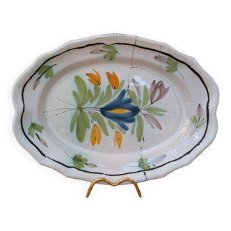 Old oval dish with floral motif called black bottom with staples
