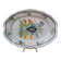 Old oval dish with floral motif called black bottom with staples