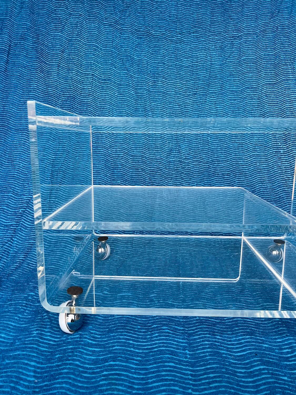 Translucent plexiglass storage drawer/cabinet on wheels.