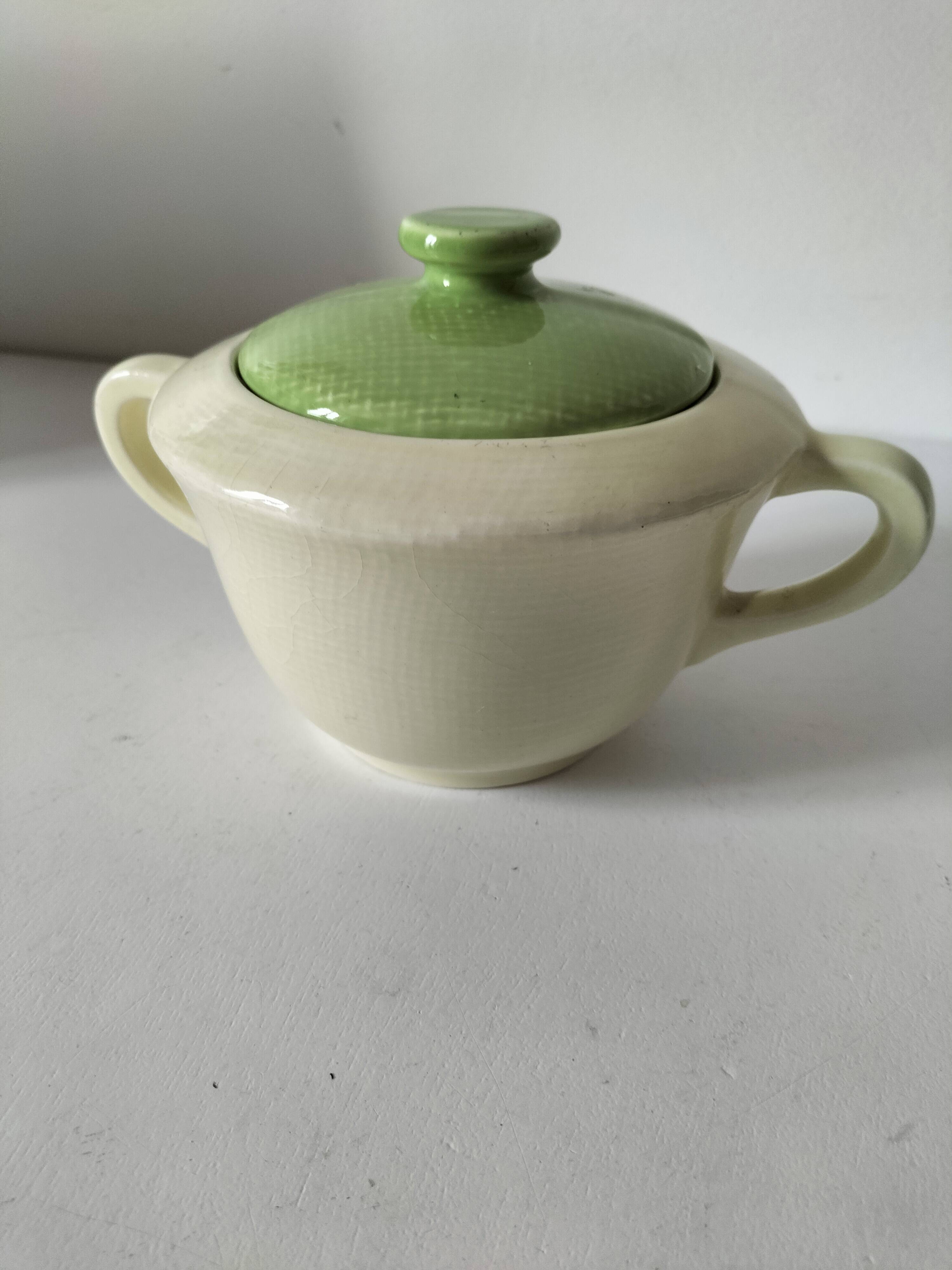 Two sugar bowls and a textured plate in turquoise and green Salins earthenware.