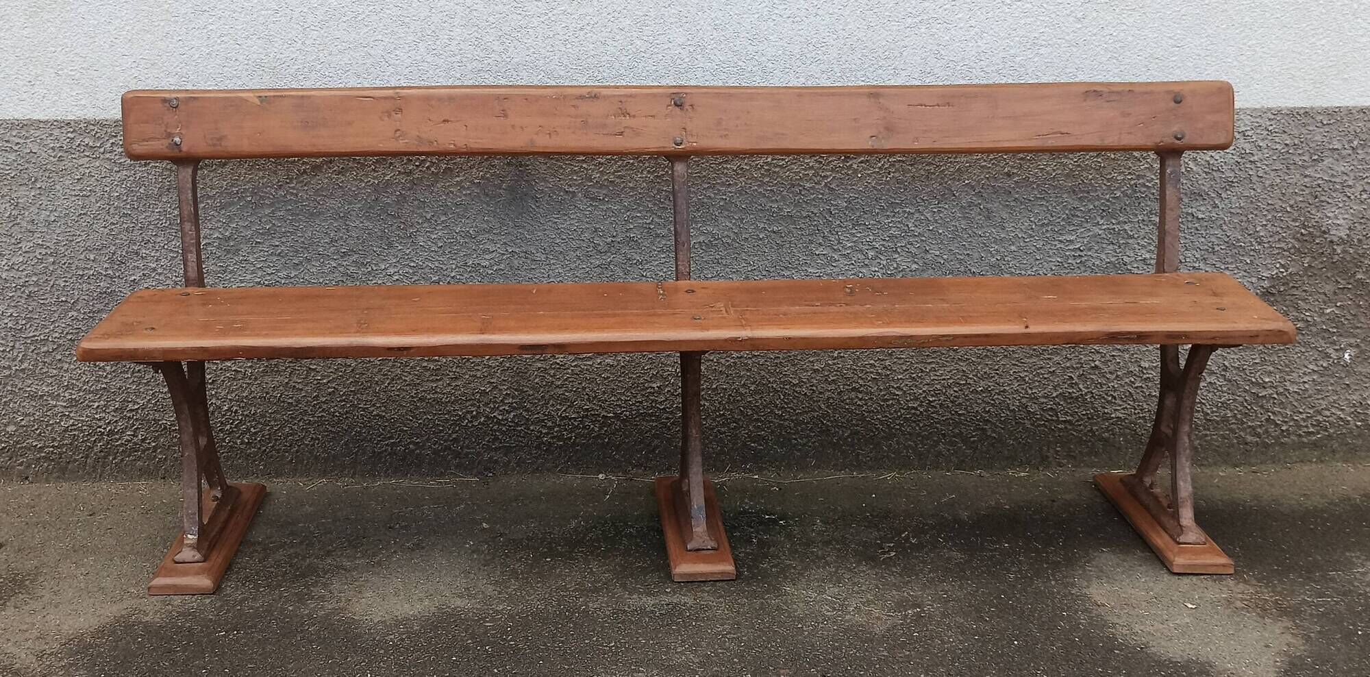 Old wooden bench with cast iron base
