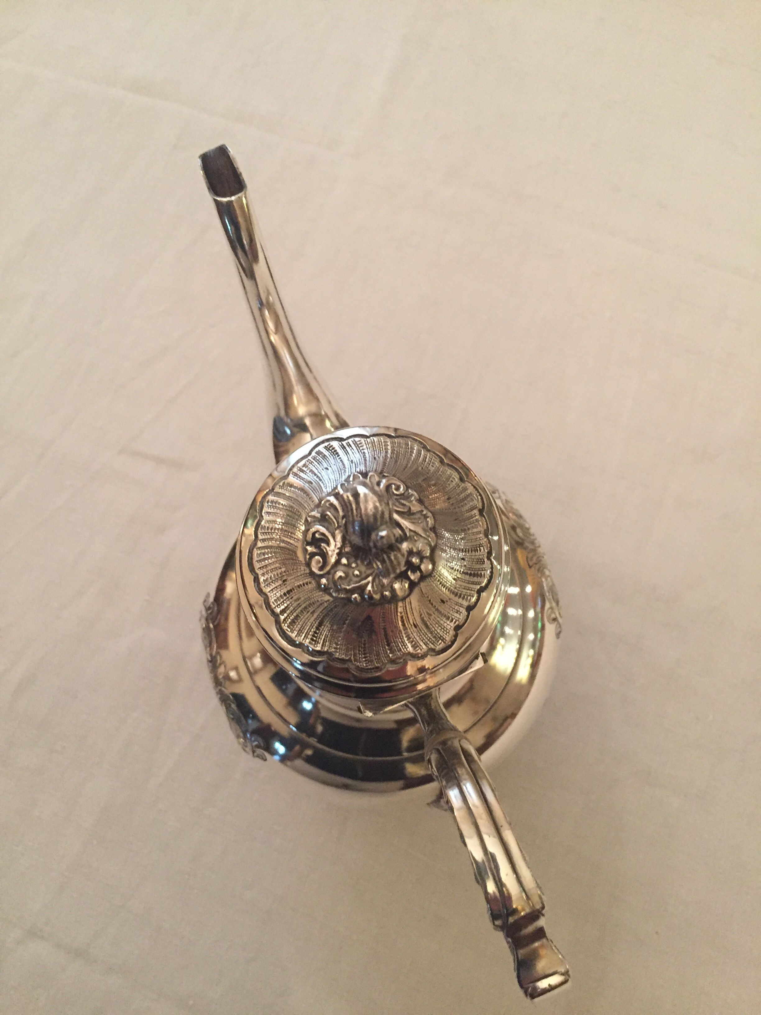 Silver metal pourer with rocker decoration