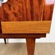 1950s bedside table in varnished wood veneer and brass.