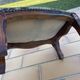 Antique wooden footstool with hand-carved details and floral upholstery –