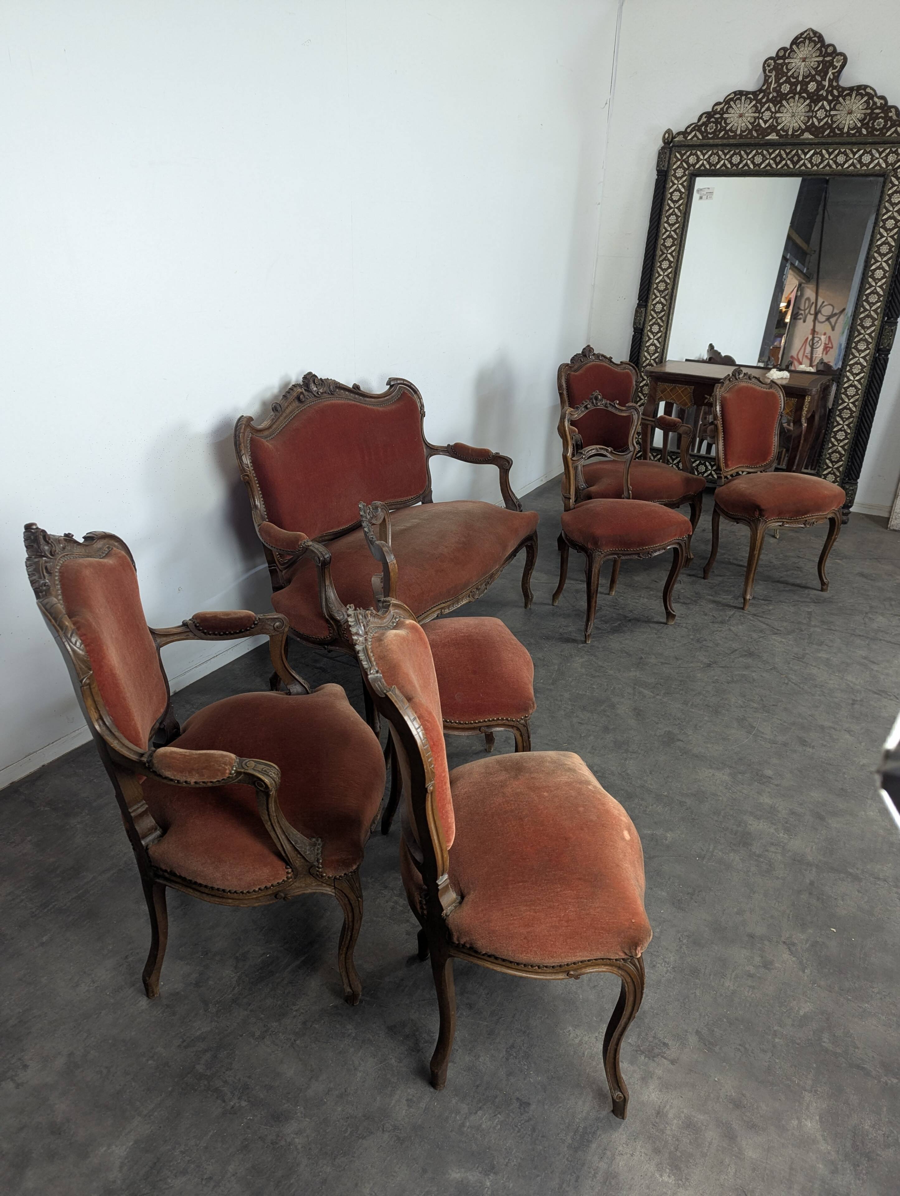 Louis XV style salon in carved walnut with orange velvet, seven pieces.