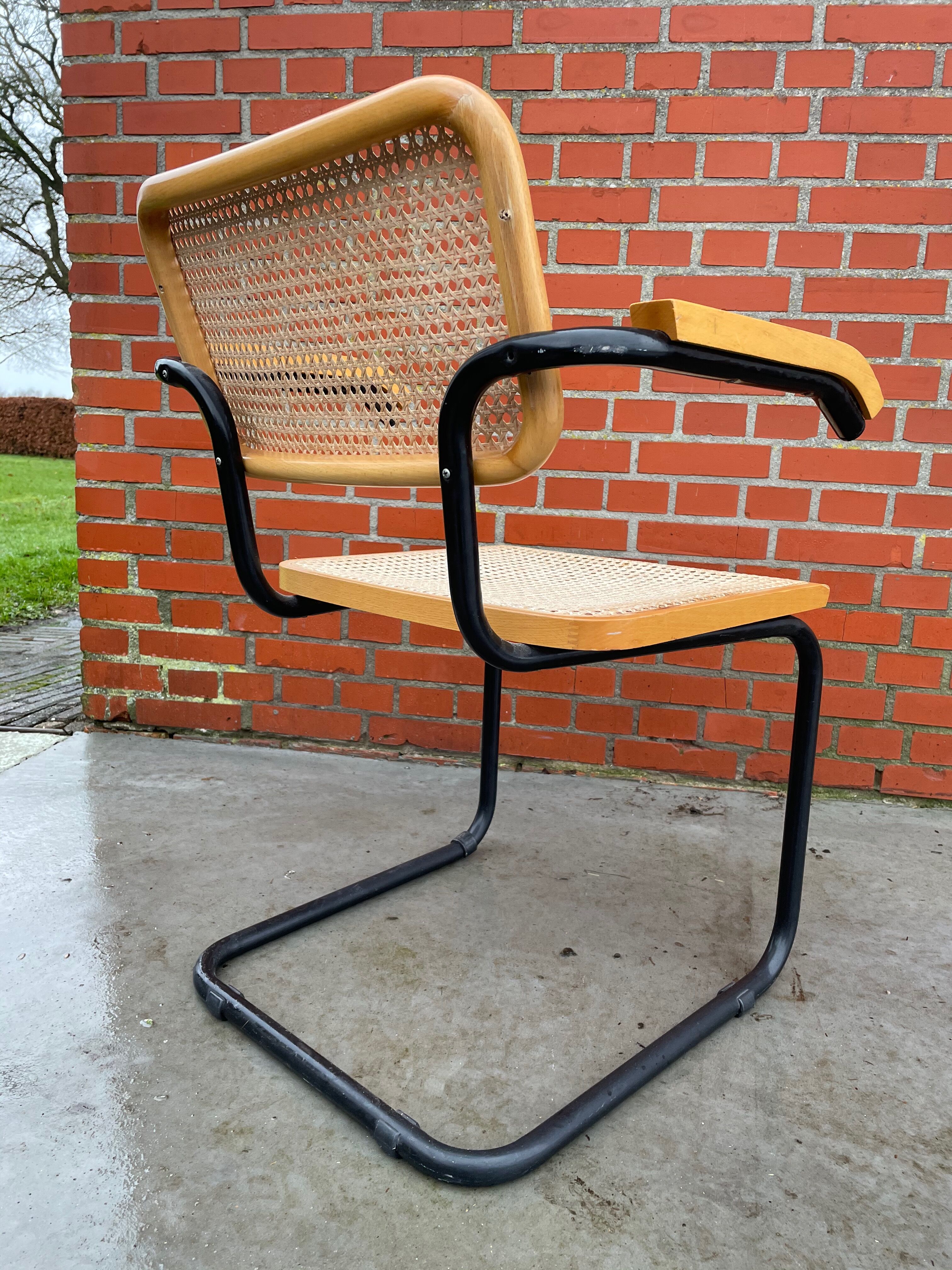 Cesca model chair designed by Marcel Breuer with black-framed armrests