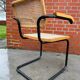 Cesca model chair designed by Marcel Breuer with black-framed armrests
