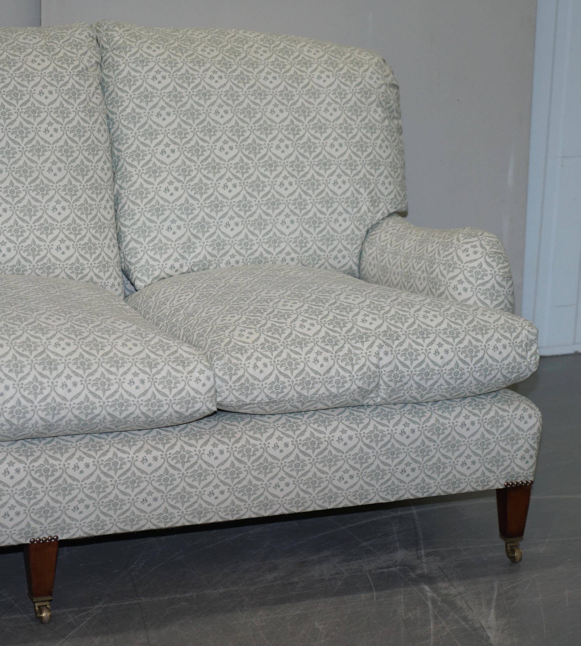 Howard & Sons canapé with feather cushions and ticking fabric, Victorian style.